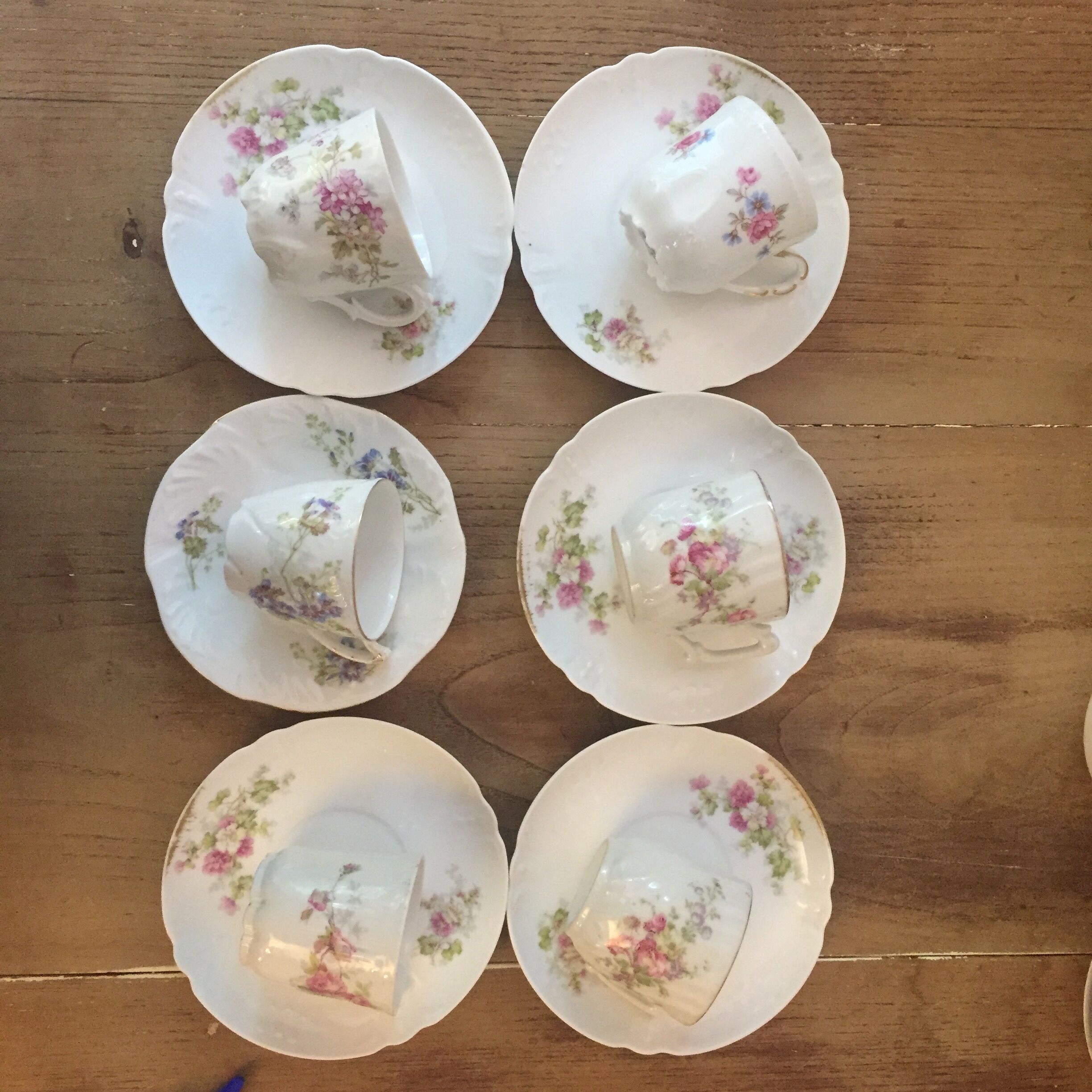 6 antique cups and mismatched saucers