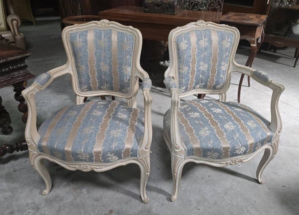 Pair of Louis XV style armchairs, in moulded and patinated wood.