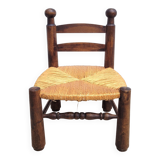 Low chair in turned wood and straw