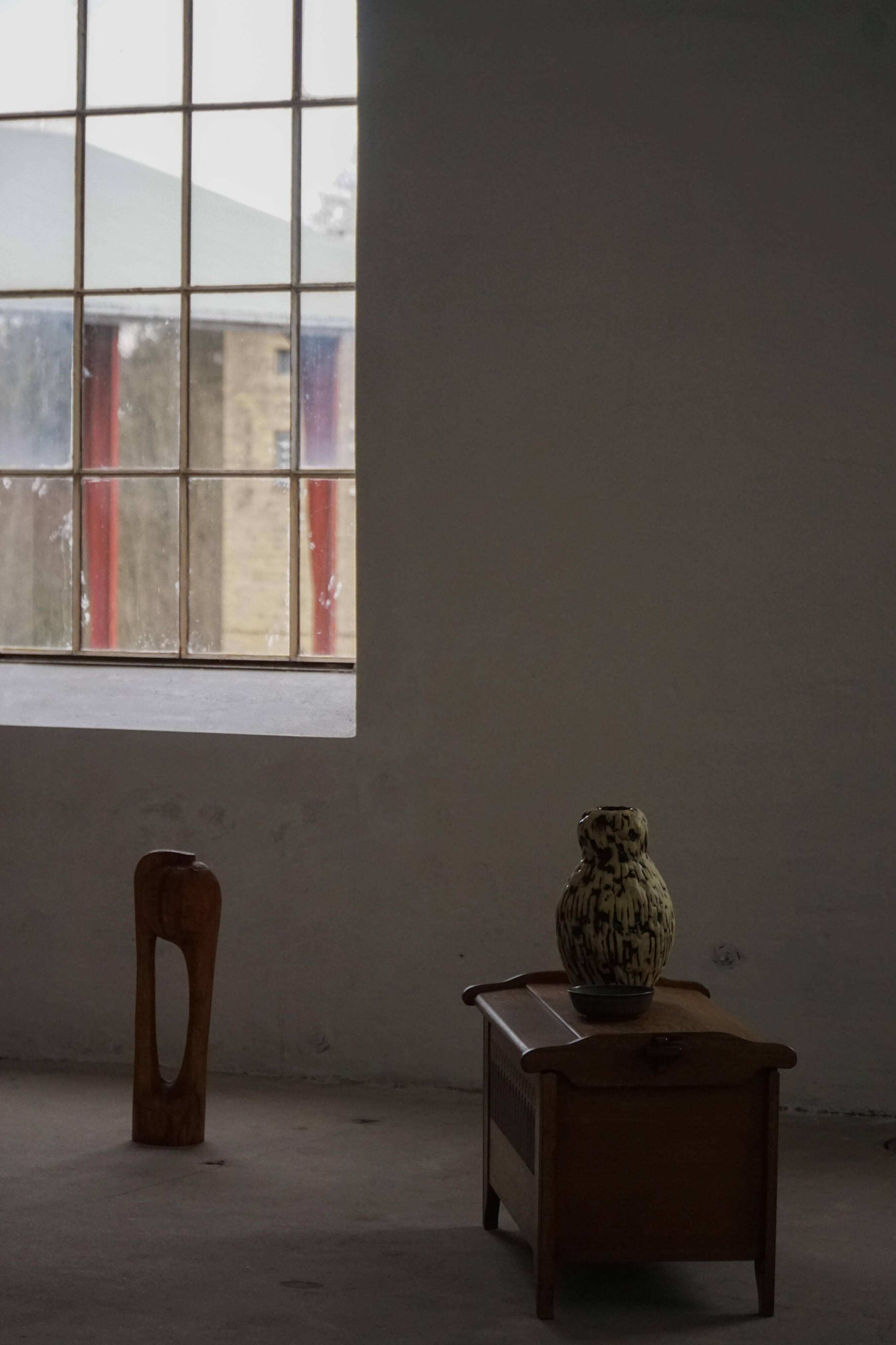 Modern Danish oak commode with decorative relief sculpture, mid-20th century.