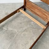 Brutalist style bed with chain and straw