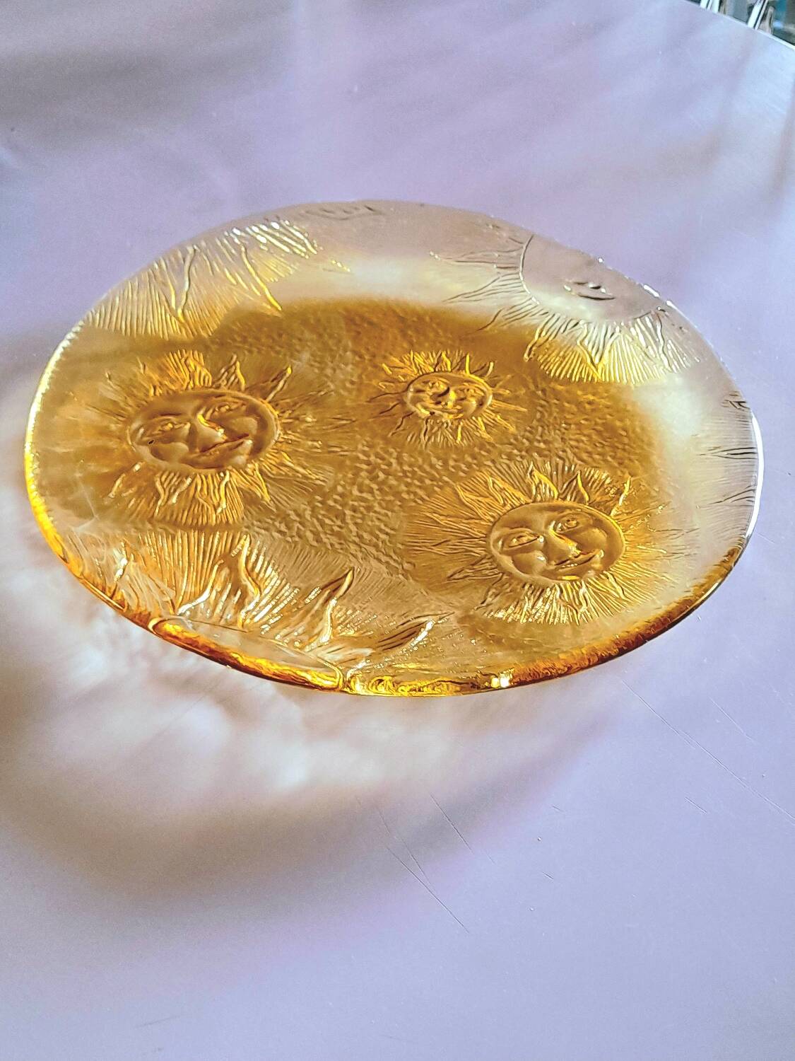 Glass plate decorated with suns, 1980.