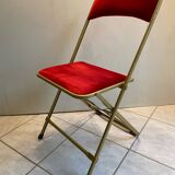 Velvet folding chair with gold metal.