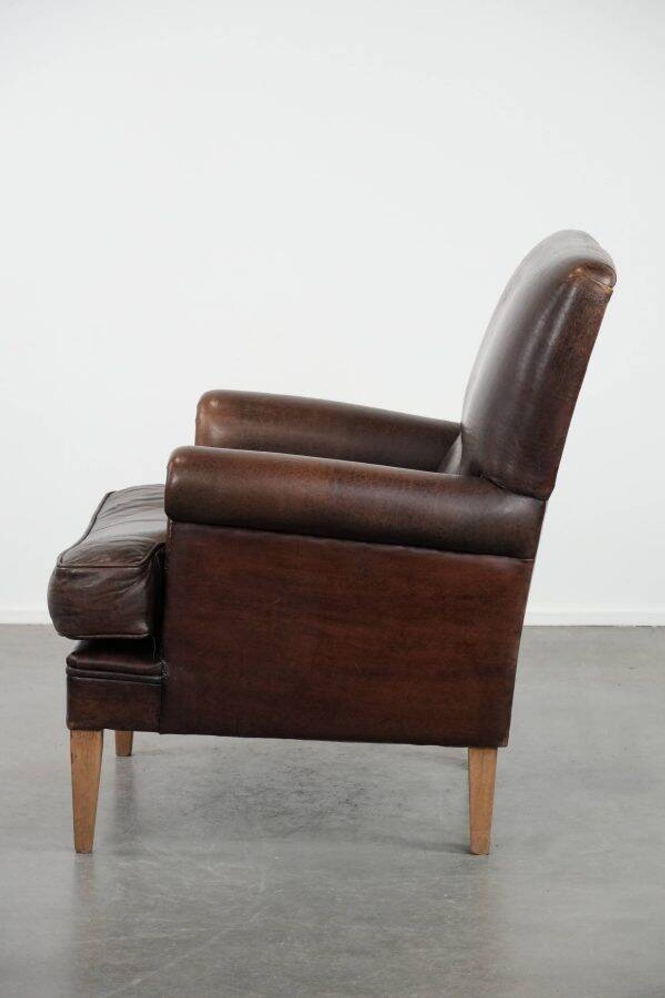 Characterful sheep leather armchair with a beautiful deep colour