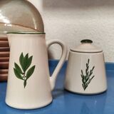 White ceramic pot and mini pitcher with bay leaf illustration