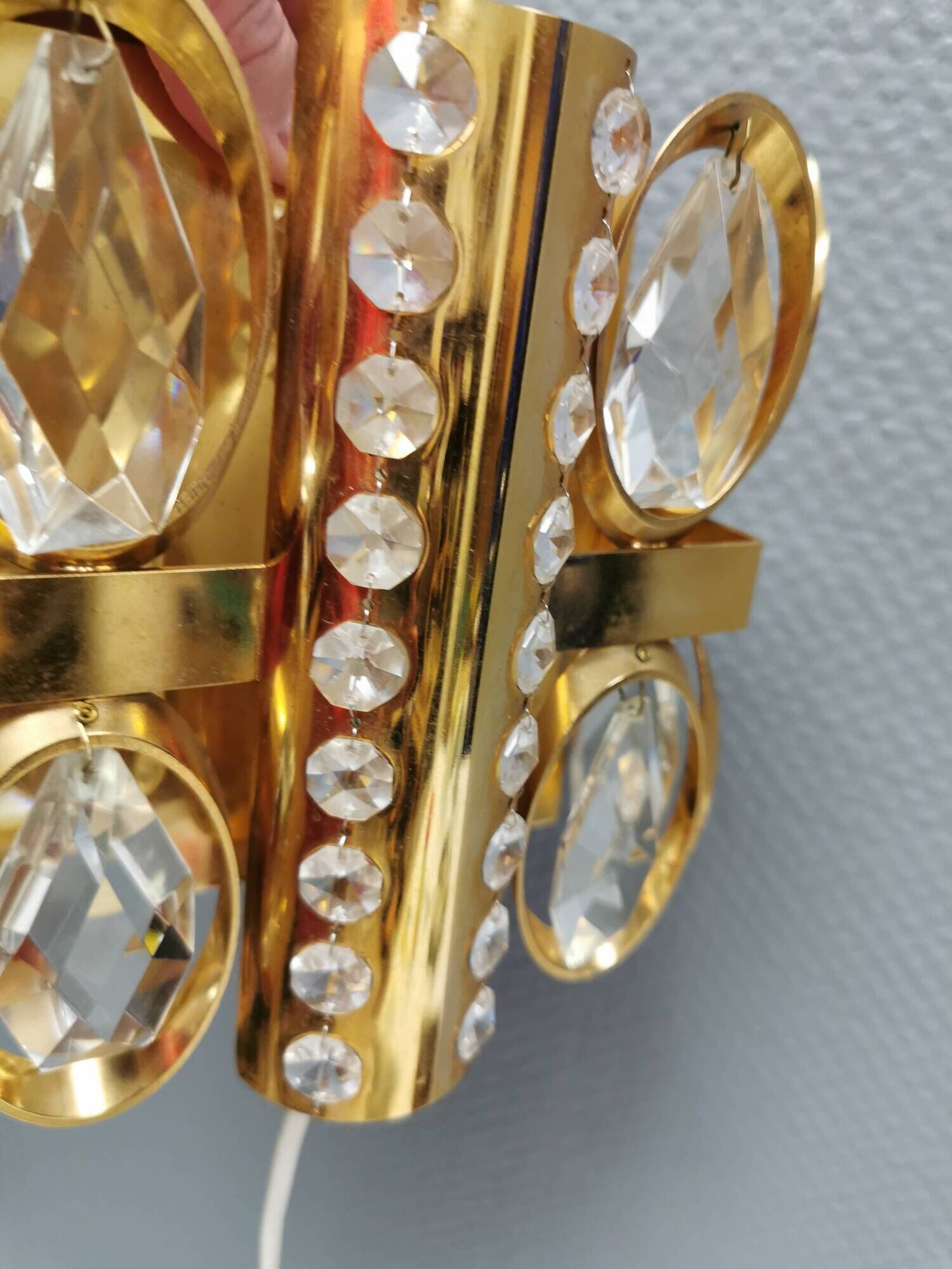 Swedish wall lamp in gold-colored metal with glass prisms. Estimated 1970-80s.
