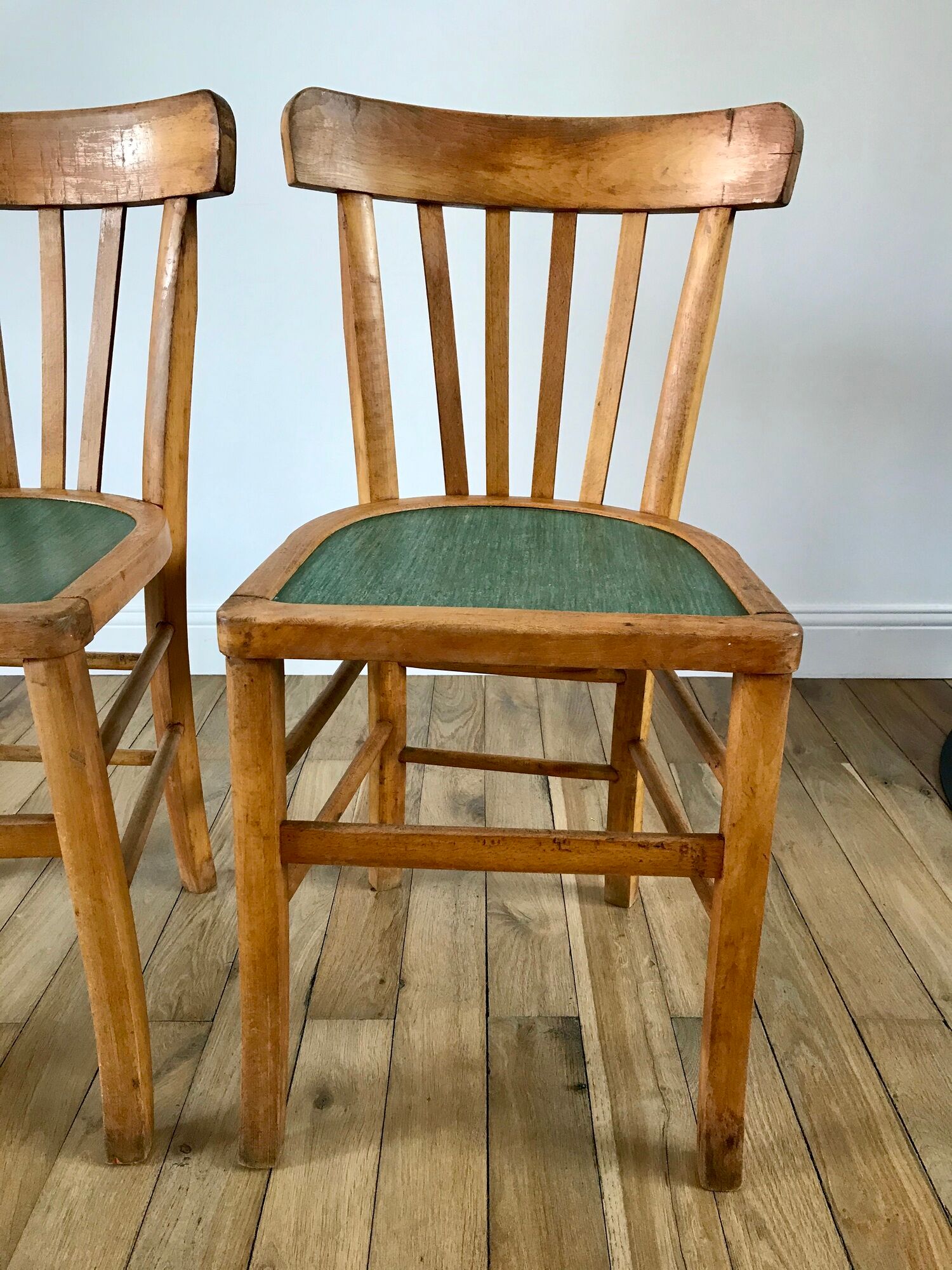 Pair of bistro chairs in light curved wood and green seat 1950s