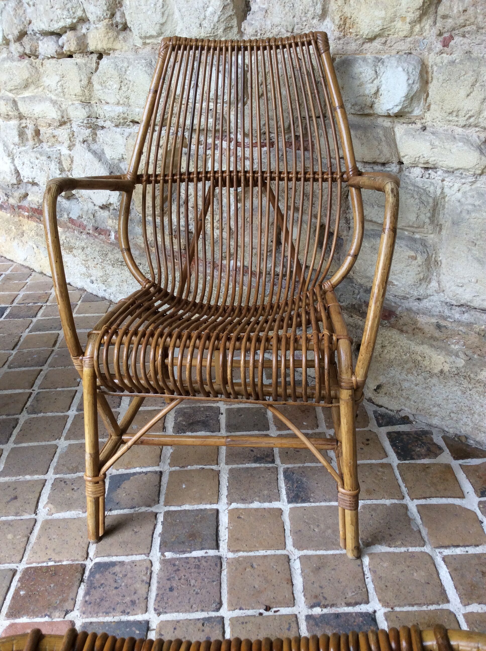 Rattan armchair and his feet rest