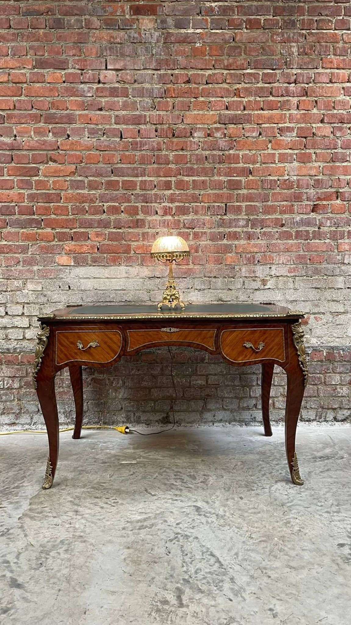 Antique French-style desk with green leather top and bronze mounts