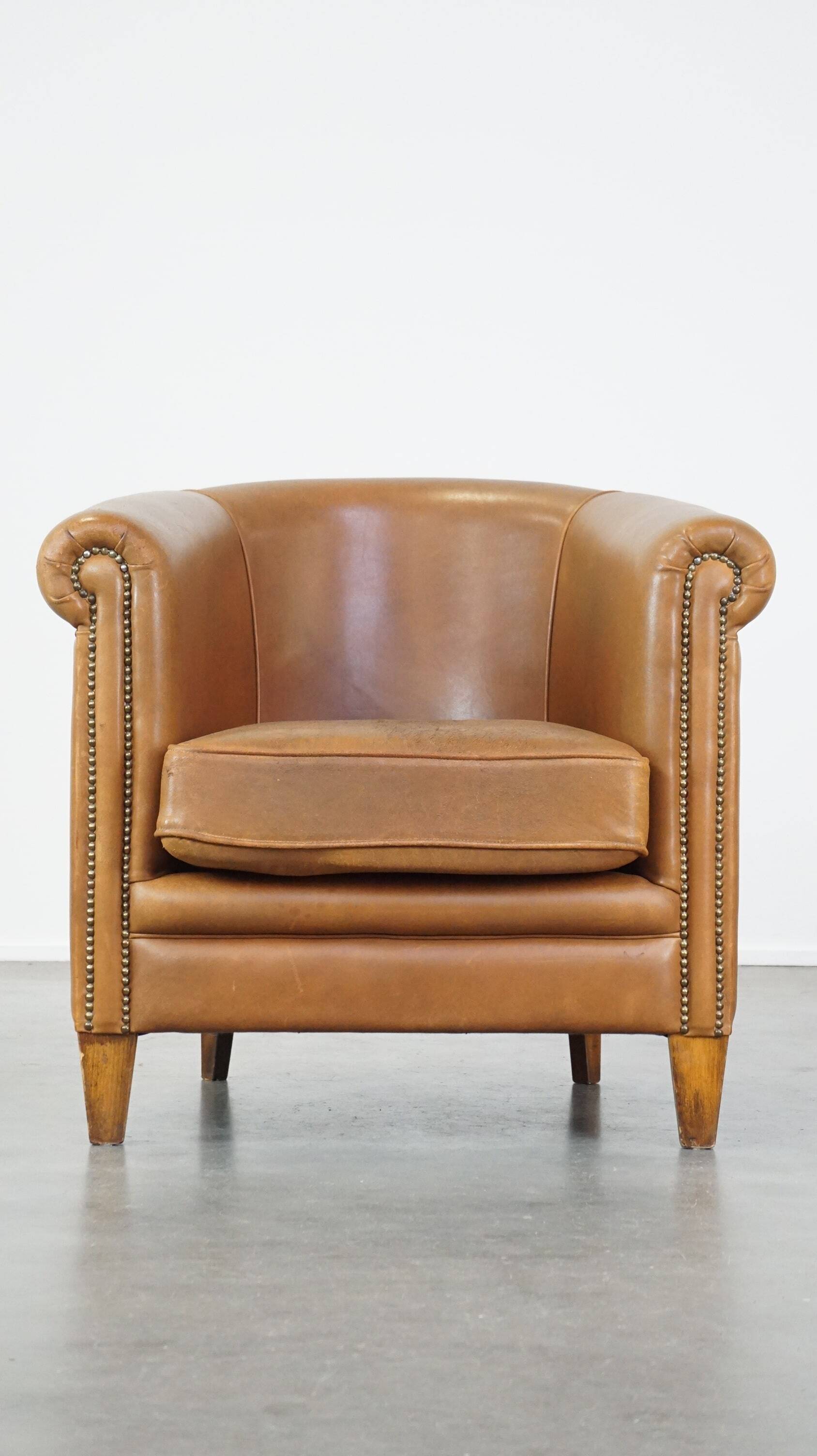 Sheep leather club chair in neutral cognac colour and in good condition
