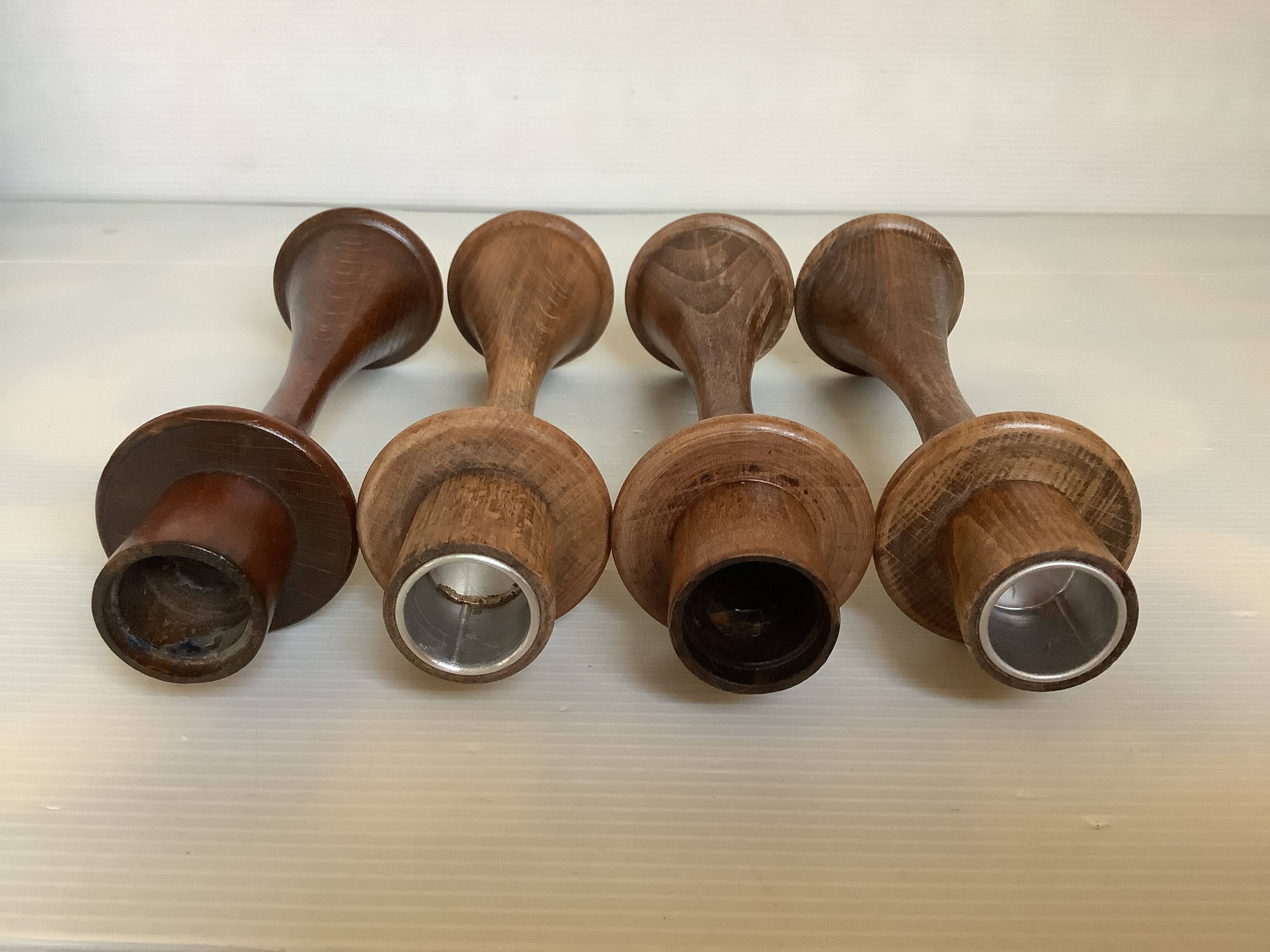 Four Scandinavian-style wooden candle holders