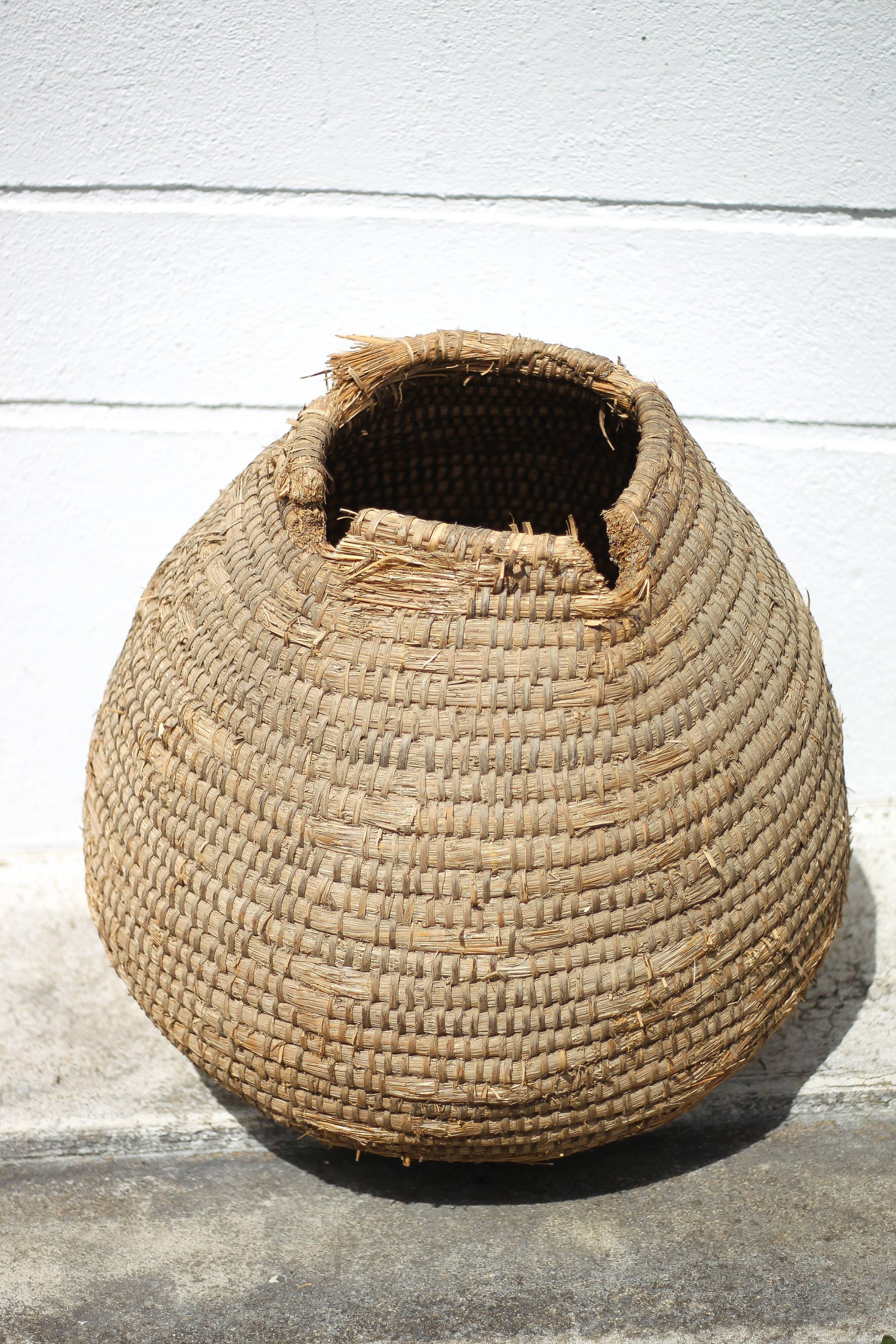 Old basket, burgundy straw and bramble, woven basket, interior decoration, pantry, flowerpot