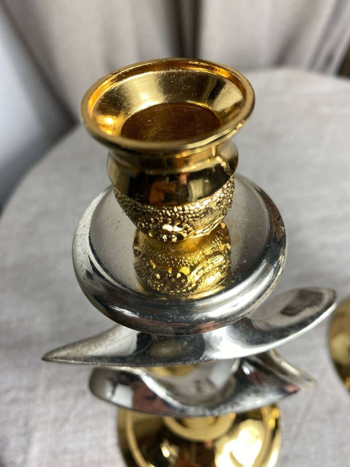 Pair of silver and gold metal candlesticks