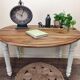 Round walnut table convertible into a console.