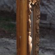 Wooden mirror decorated with gold from the 1920s