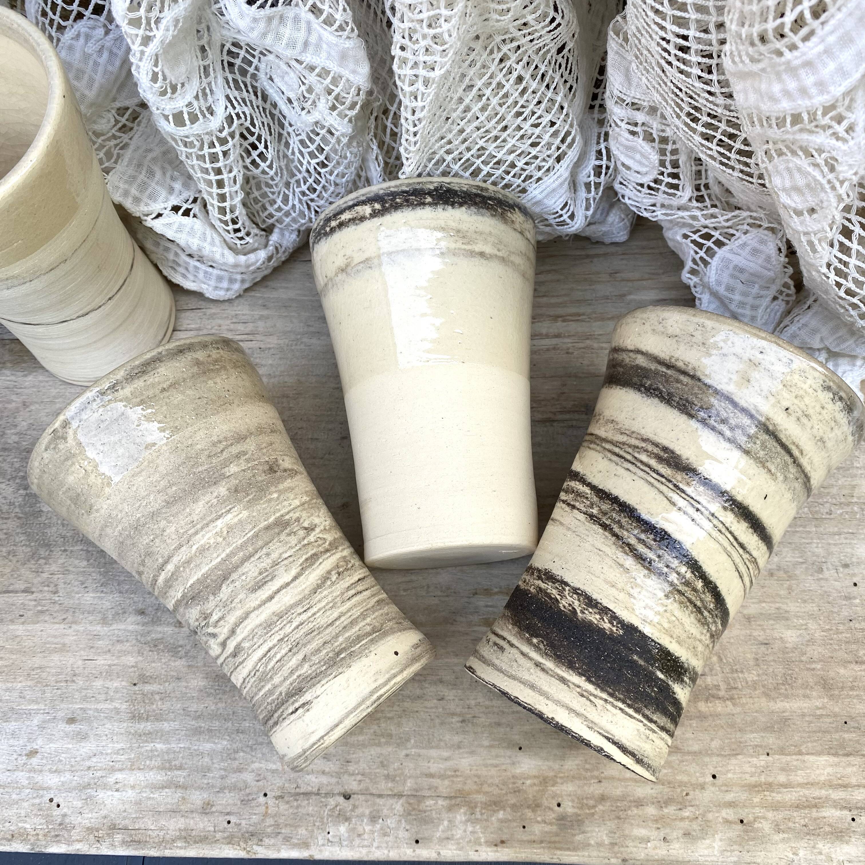 High ceramic cups made of mixed clay.