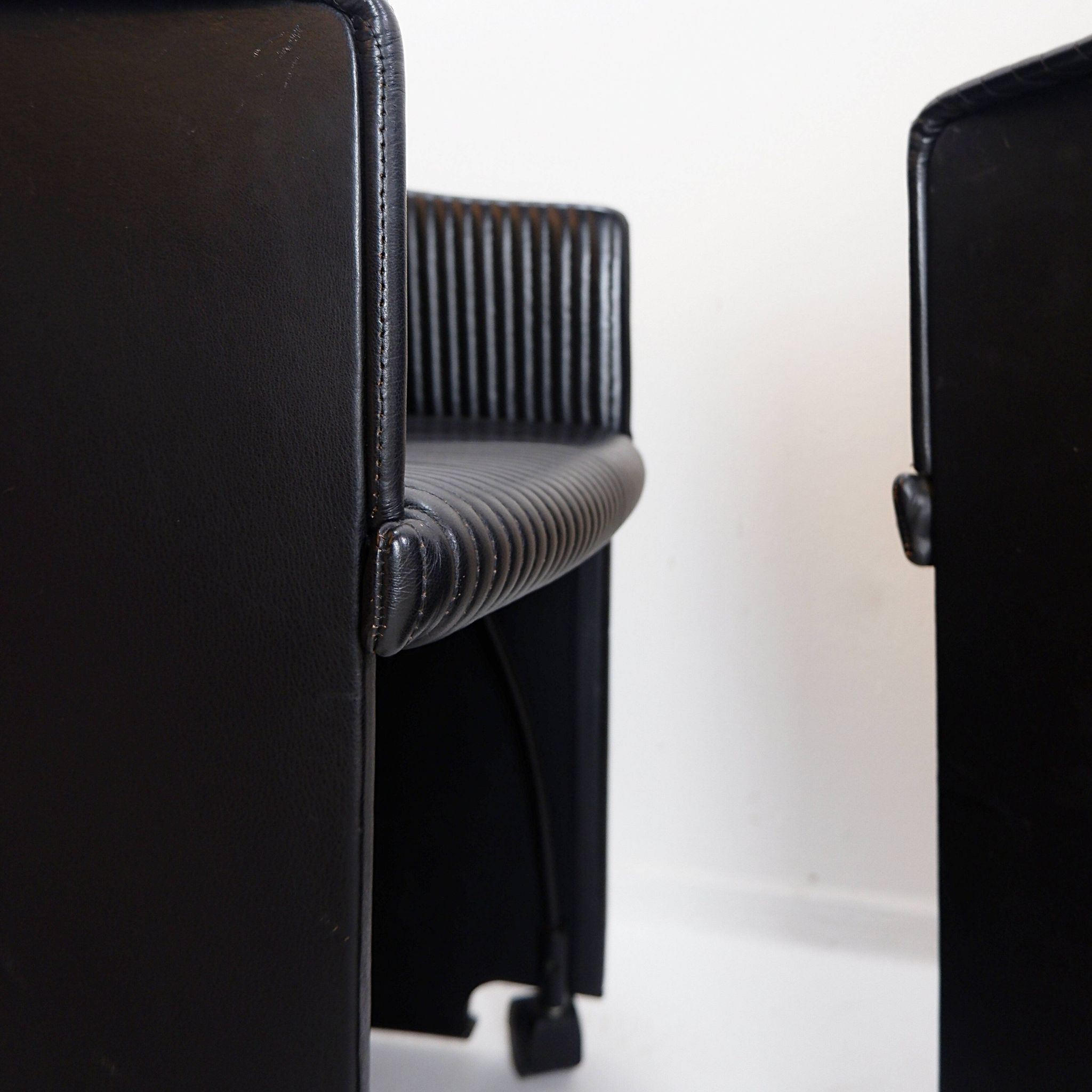 Pair of Artona armchairs in black leather by Afra and Tobia Scarpa for Maxalto.