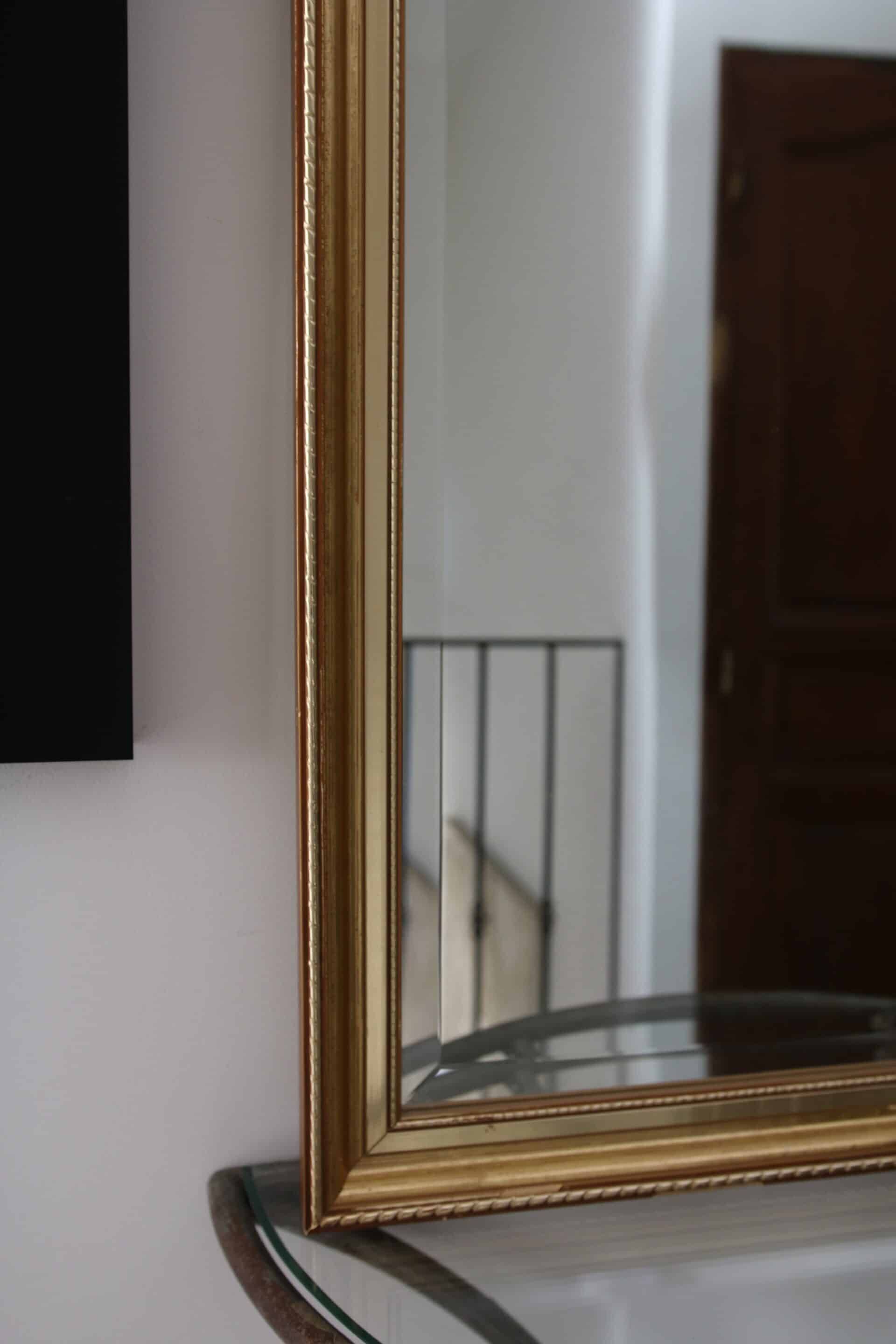 Large beveled mirror in carved wood