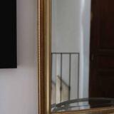 Large beveled mirror in carved wood