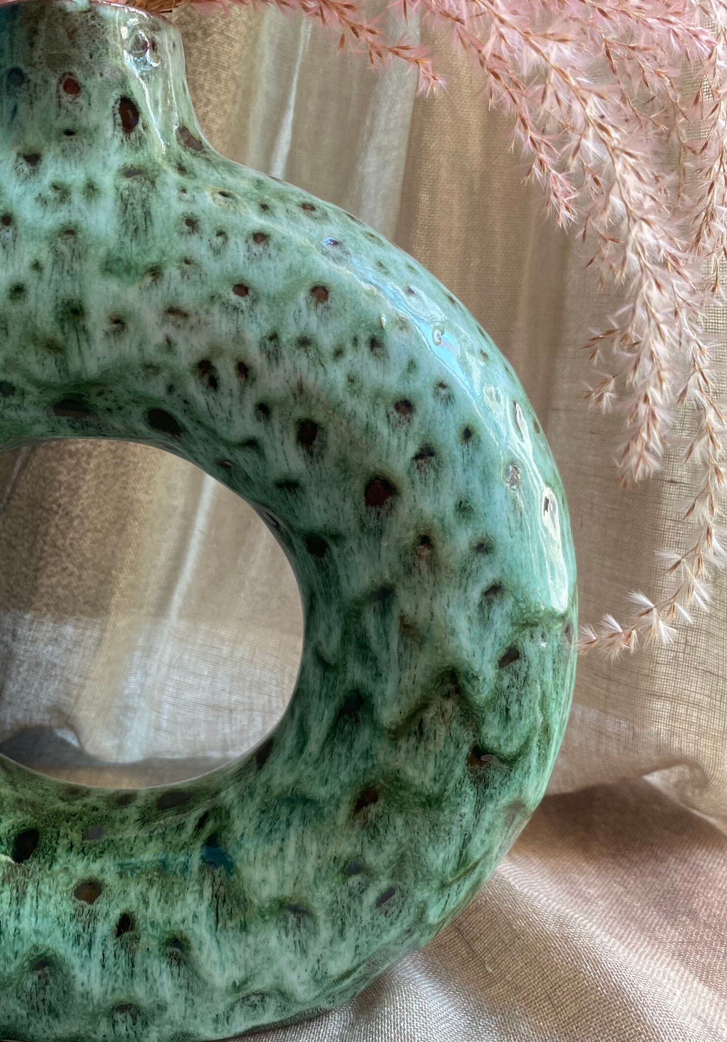 Handmade terracotta donut vase in light green terracotta