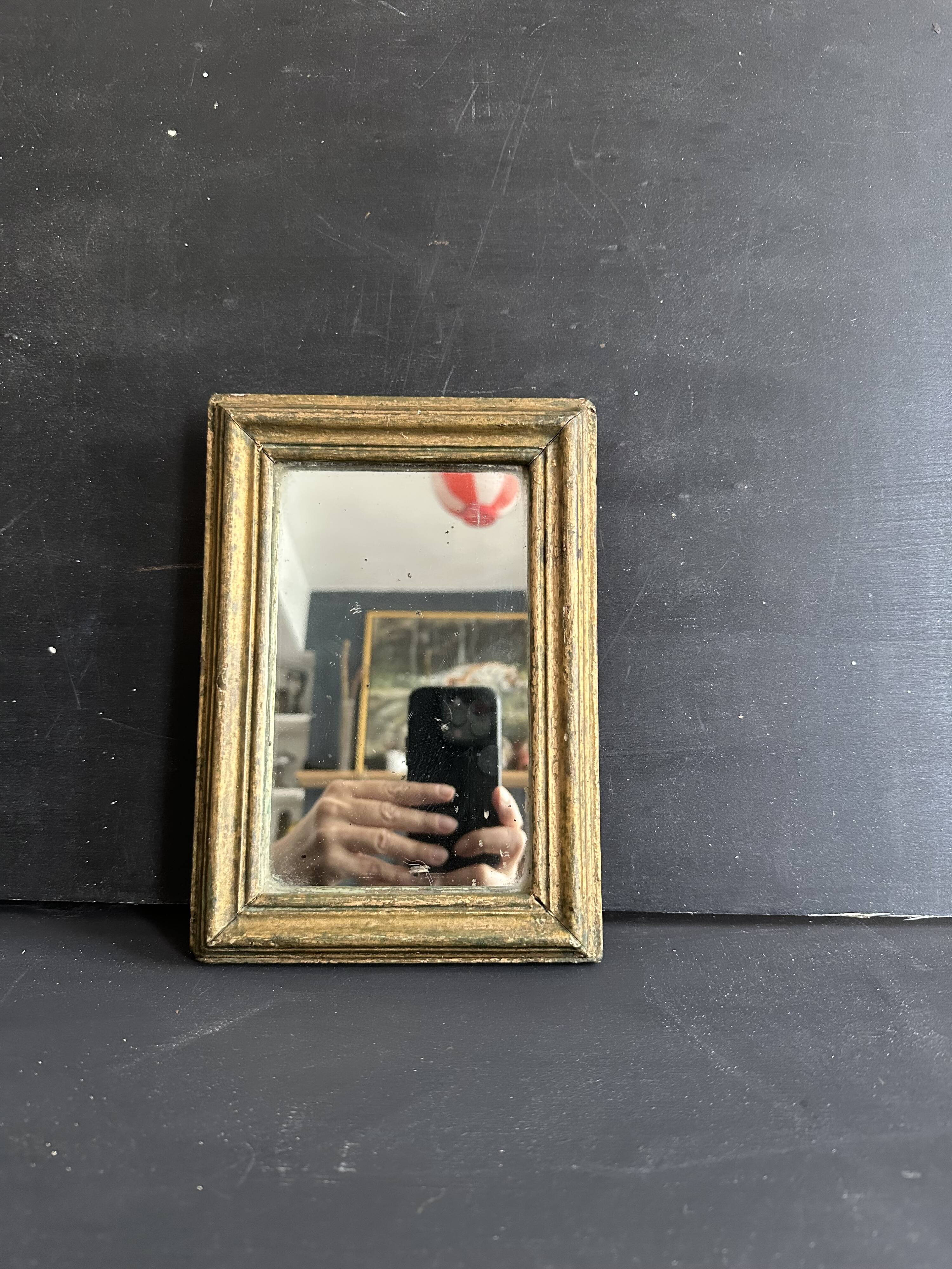 Miniature mirror from the 18th century in gilded wood, mercury glass.