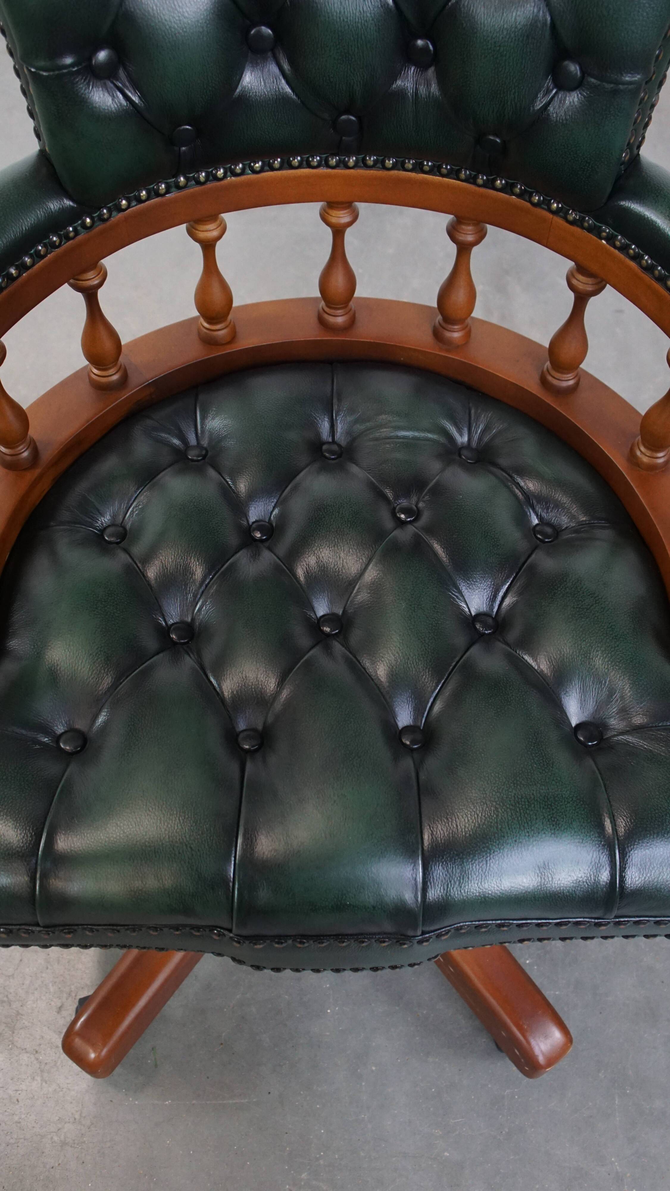 Dark green chesterfield office chair in cowhide leather on wheels
