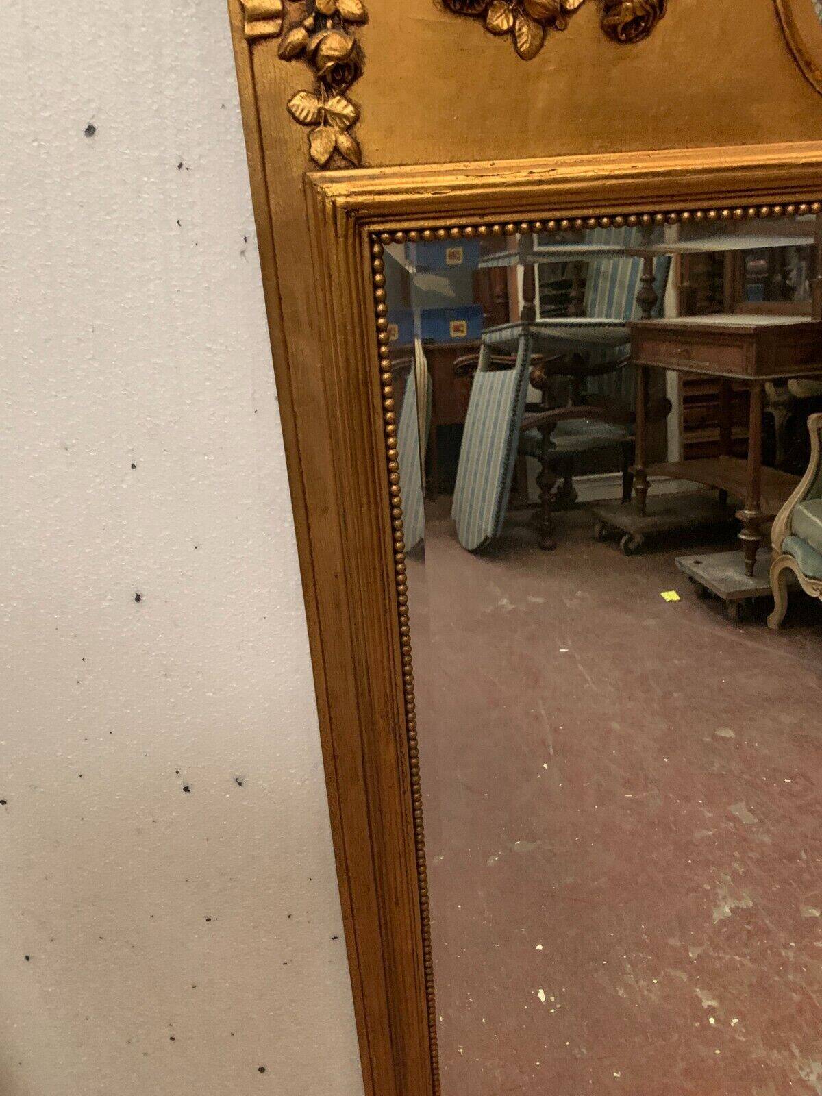 Louis XVI style mirror in wood and gilded stucco 20th century