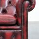 Red English cowhide Chesterfield armchair finished with decorative nails