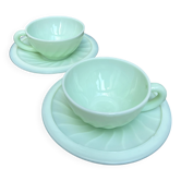 Two green opaline cup and saucer sets.