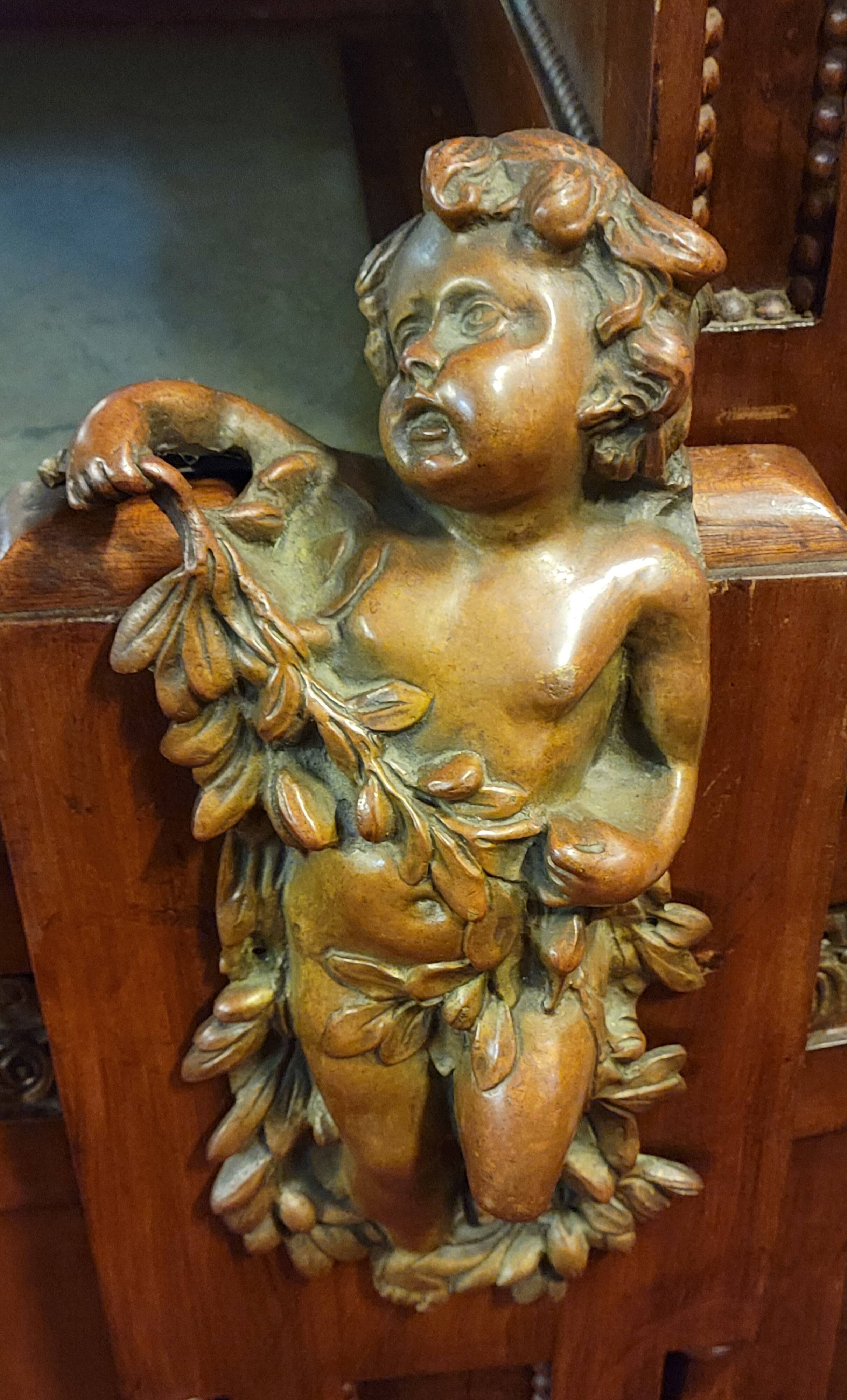 Empire style half-moon shaped mahogany bookcase with putti