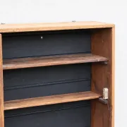 Antique wall display cabinet in natural wood and black – small glass-fronted collector's piece.