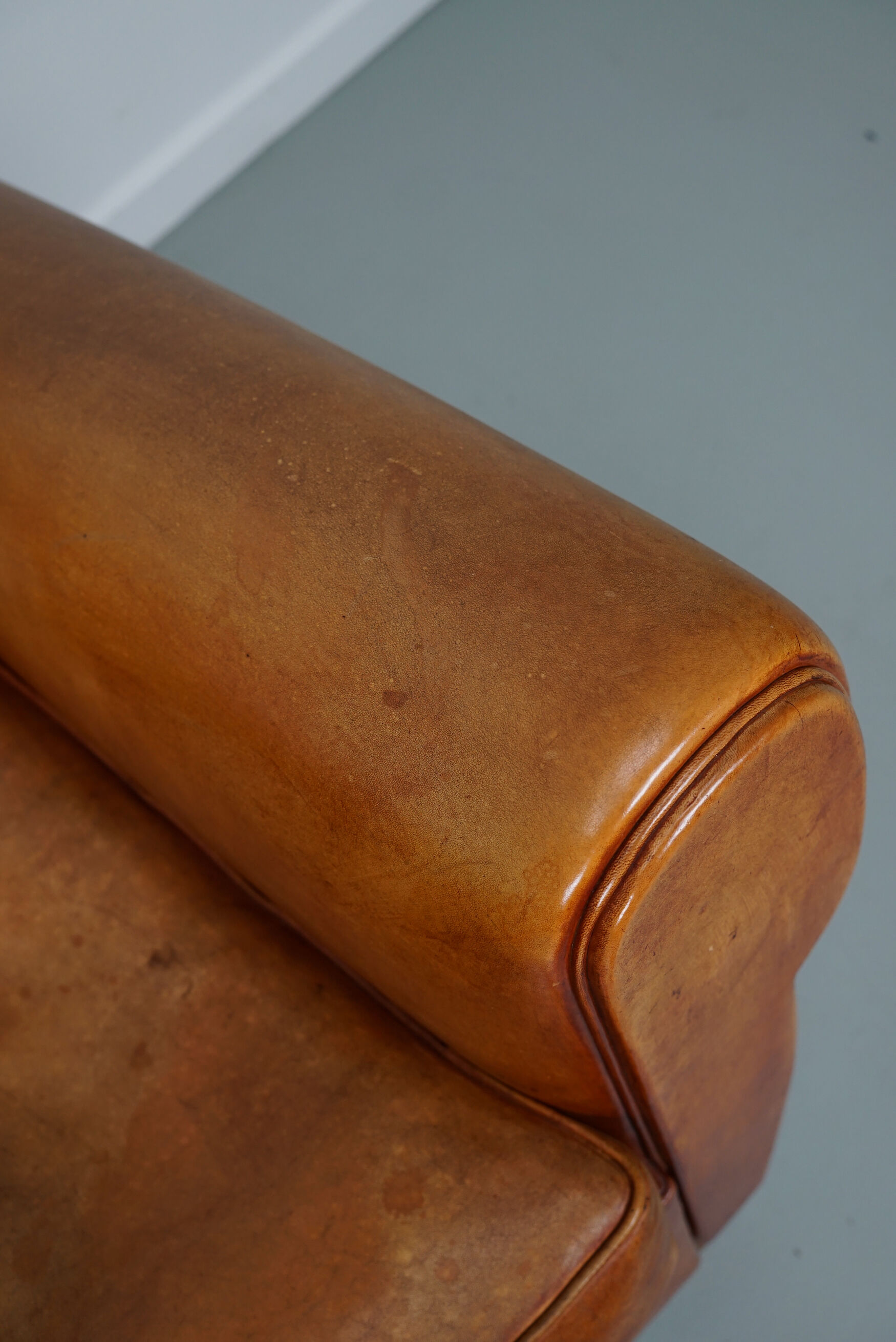 Vintage french moustache back cognac-colored leather club chair