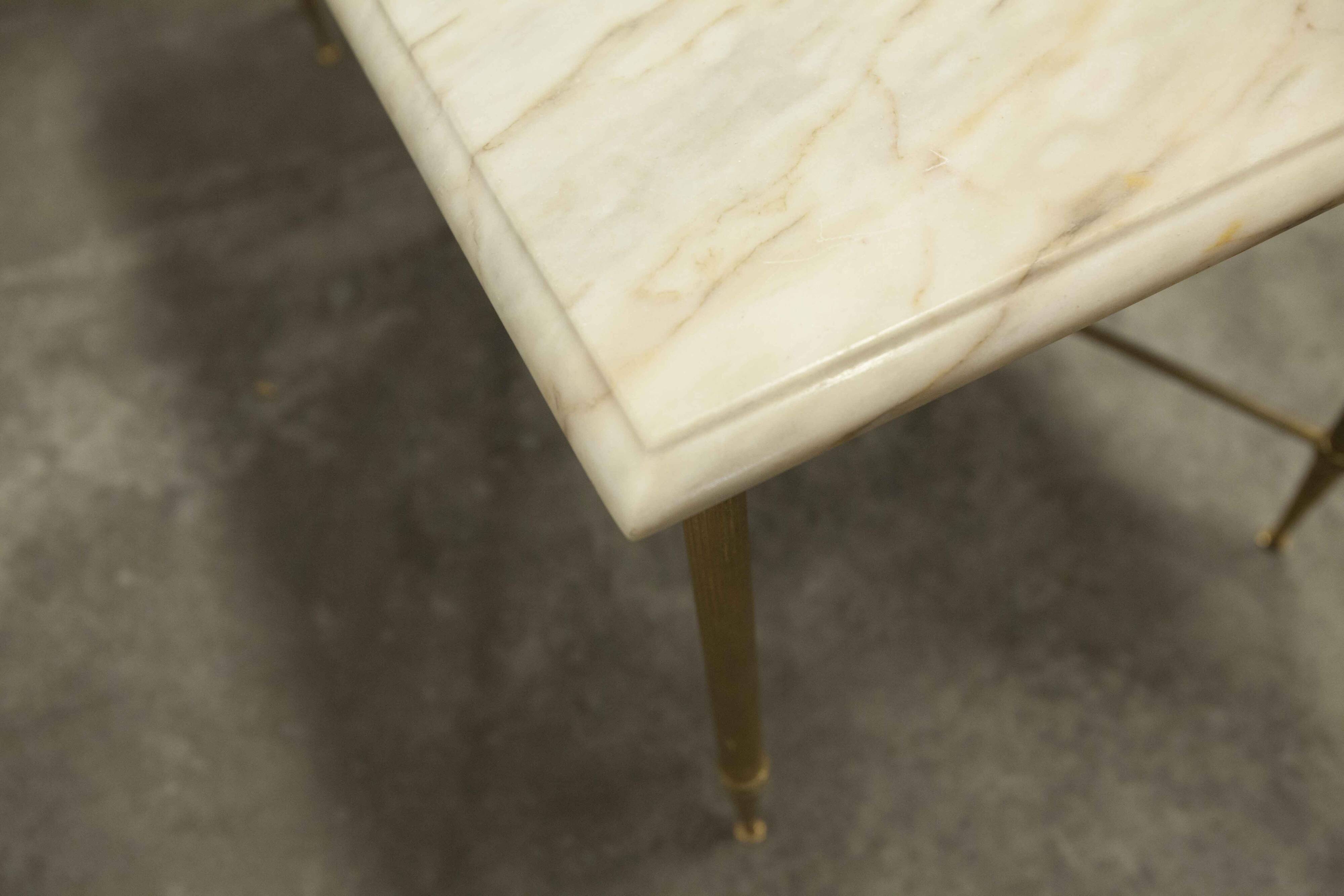 Marble coffee table with brass legs, height 46 cm.