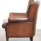 Subtle dark brown sheepskin wingback armchair with a timeless look subtle