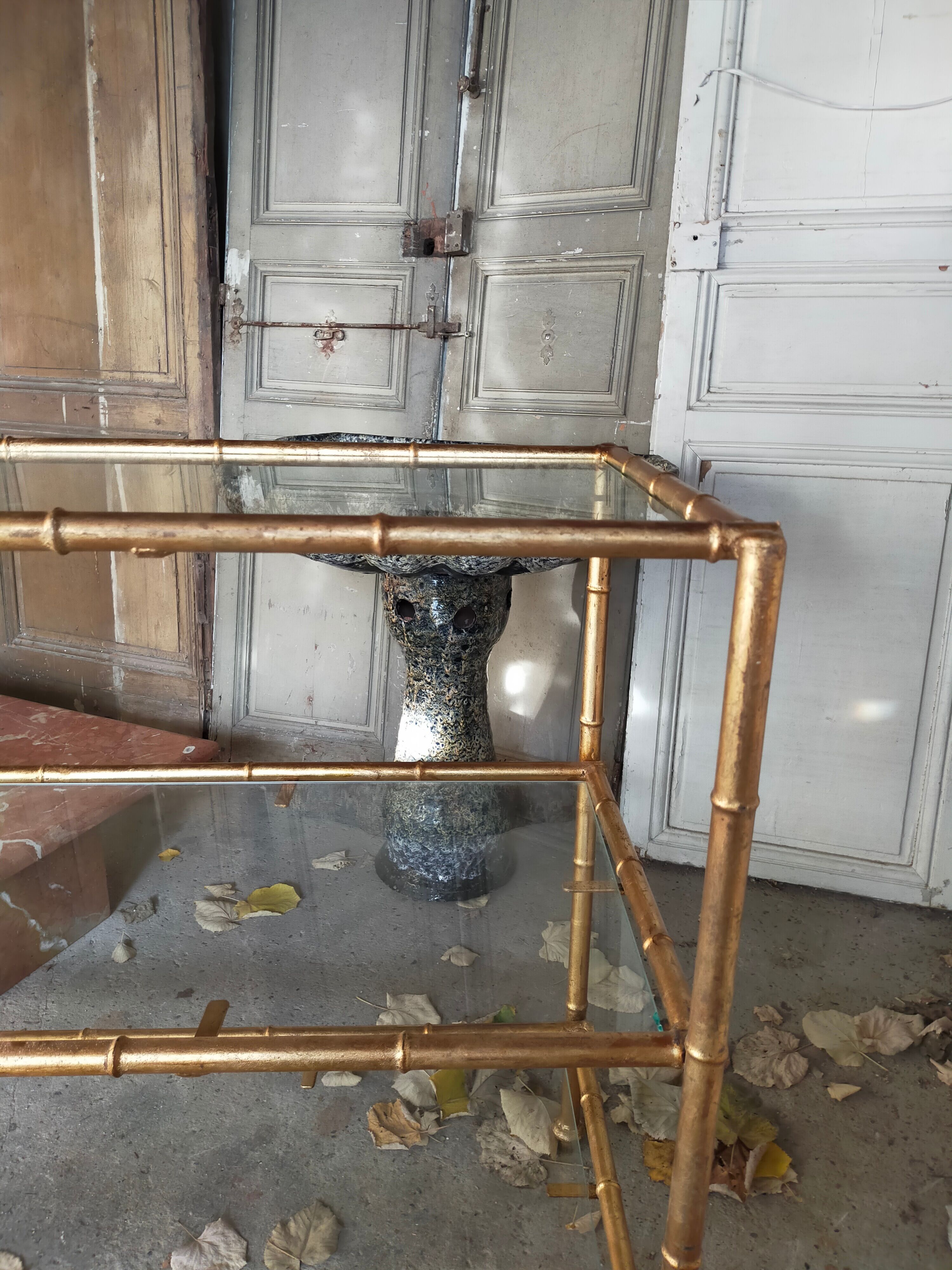 Console in gilded metal and glass