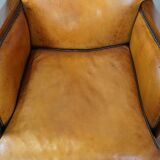 Unique, luxurious sheepskin armchair combined with wood and finished with decorative nails