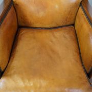 Unique, luxurious sheepskin armchair combined with wood and finished with decorative nails