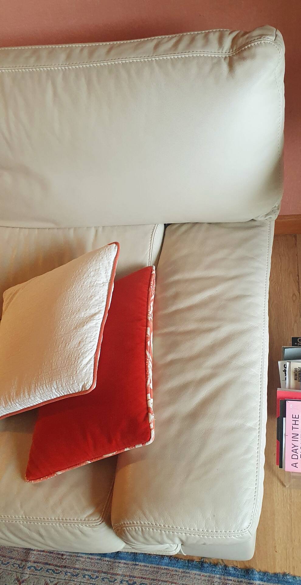 Two-seater convertible sofa bed in off-white leather by Ligne Roset.