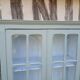 Parisian style display cabinet with 2 doors and 3 shelves in Luxembourg green.