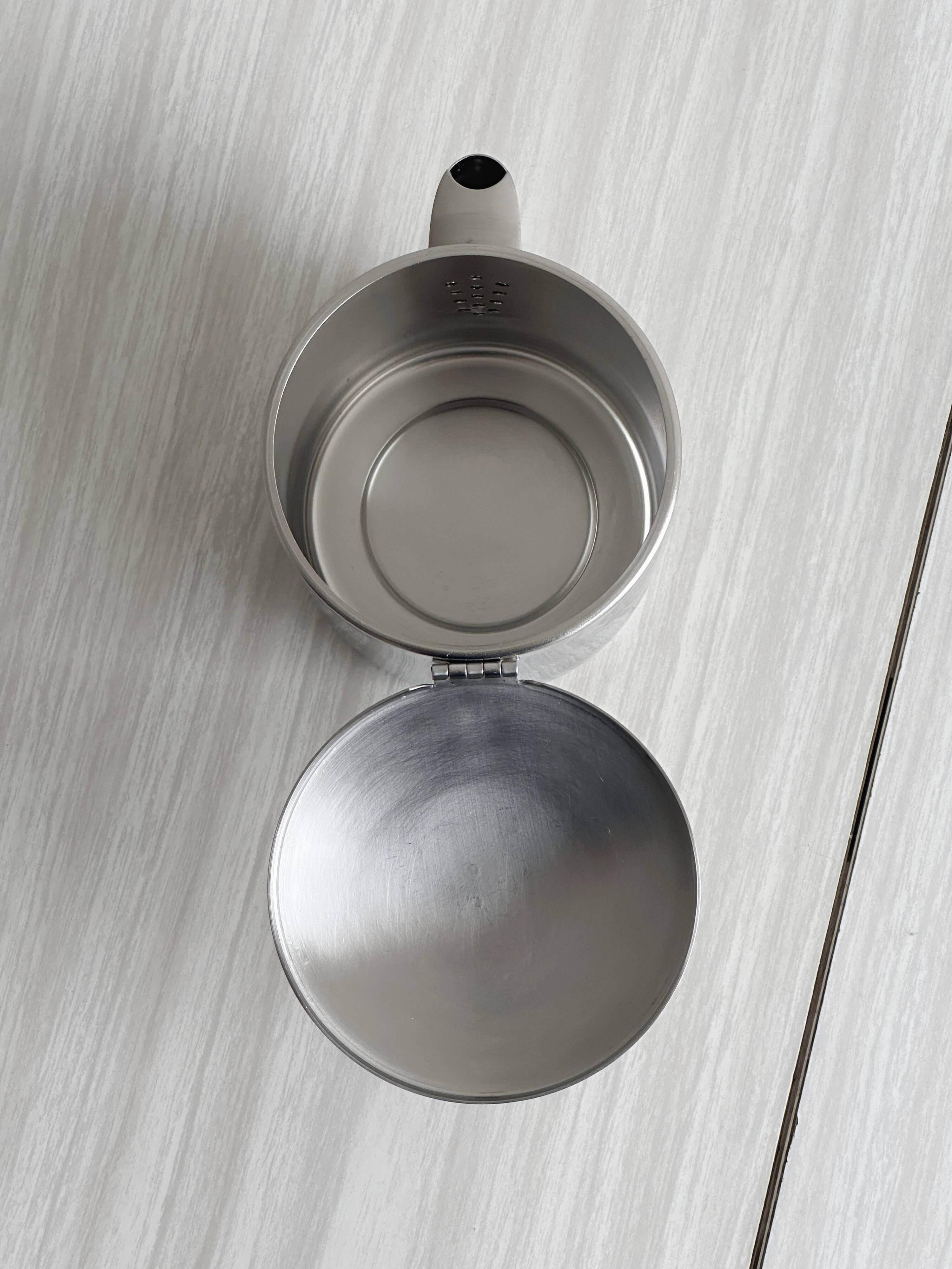 Small shiny stainless steel teapot