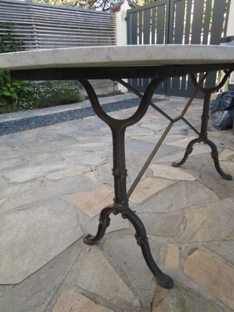 Old bistro table in marble and godin cast iron foot