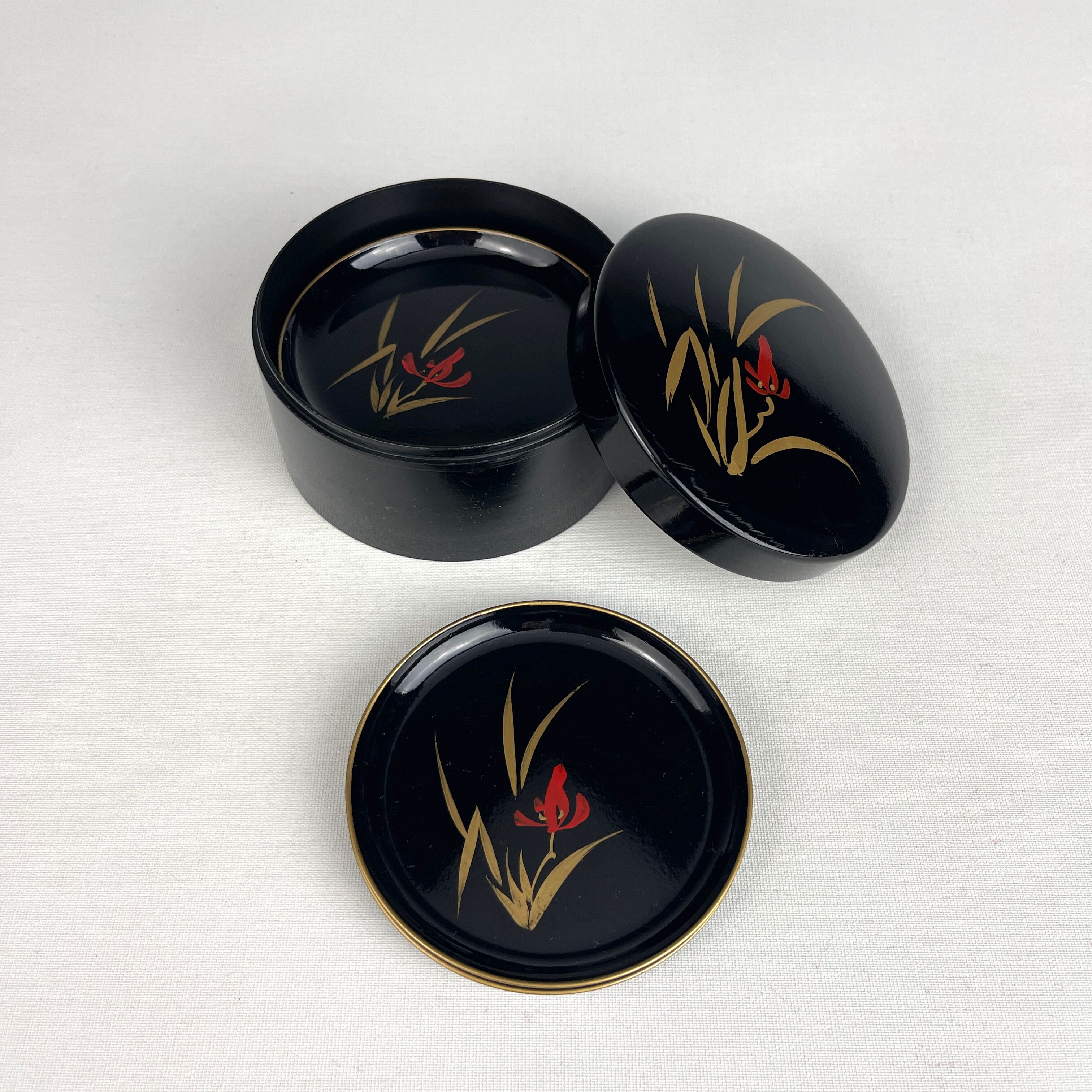 Coasters and their vintage black lacquered wooden box