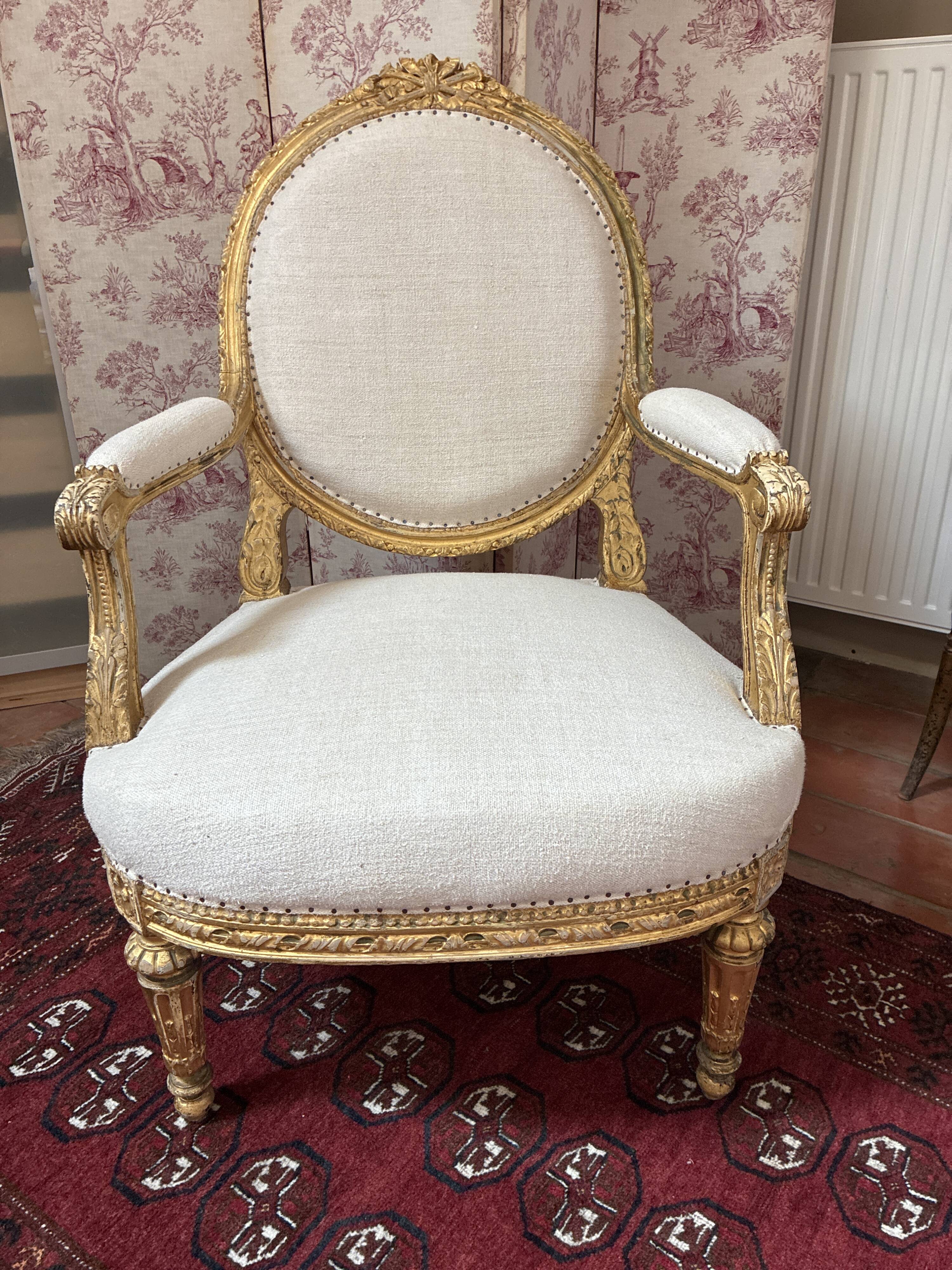 Large cabriolet armchair in Louis XVI style with gilded wood.