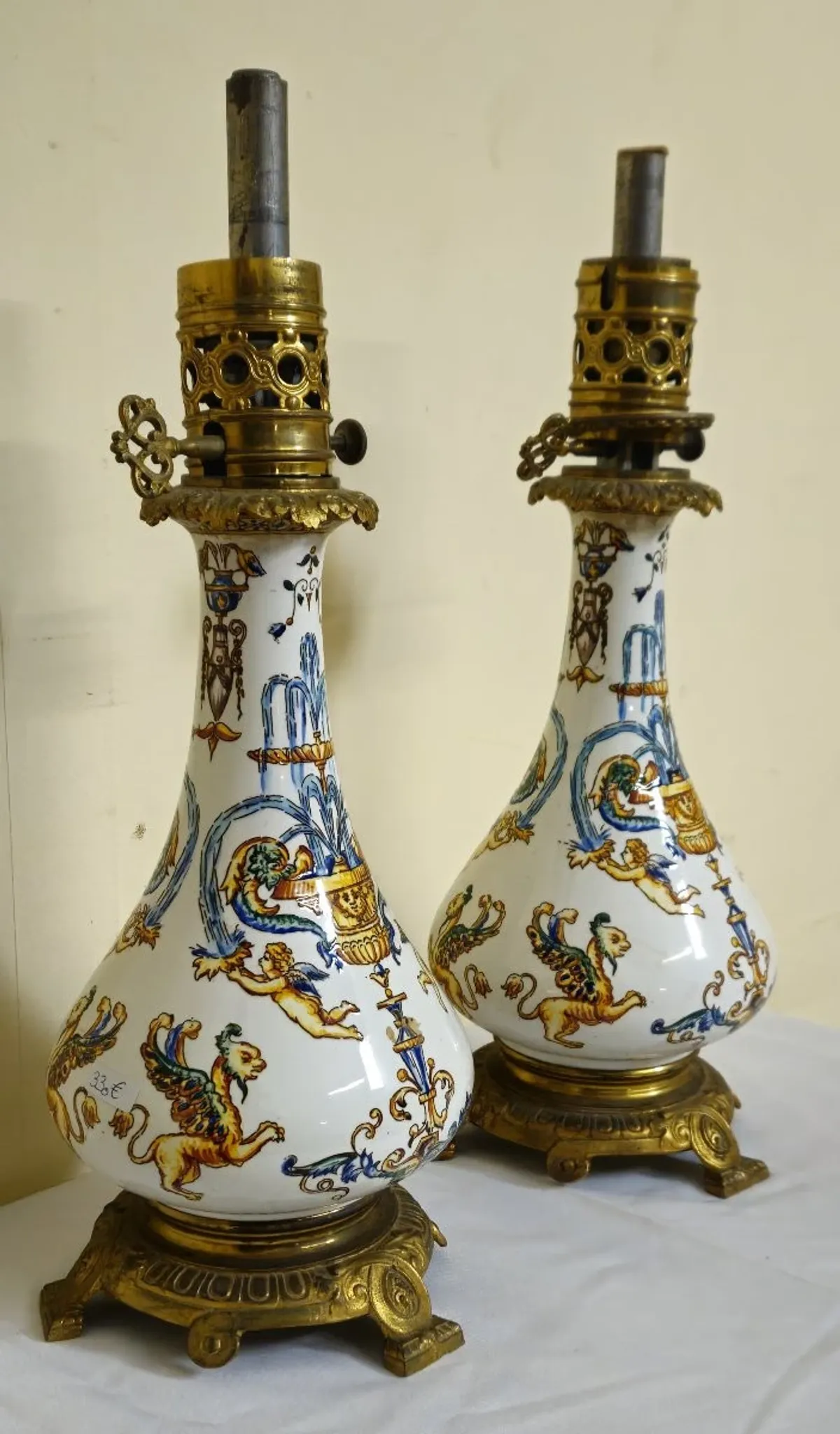 Gien: pair of antique oil lamps in fine earthenware richly decorated.
