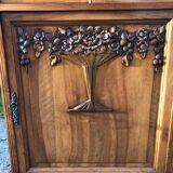 Art Deco sideboard bar cabinet in solid walnut with 3 doors and 1 richly carved tilting false drawer.