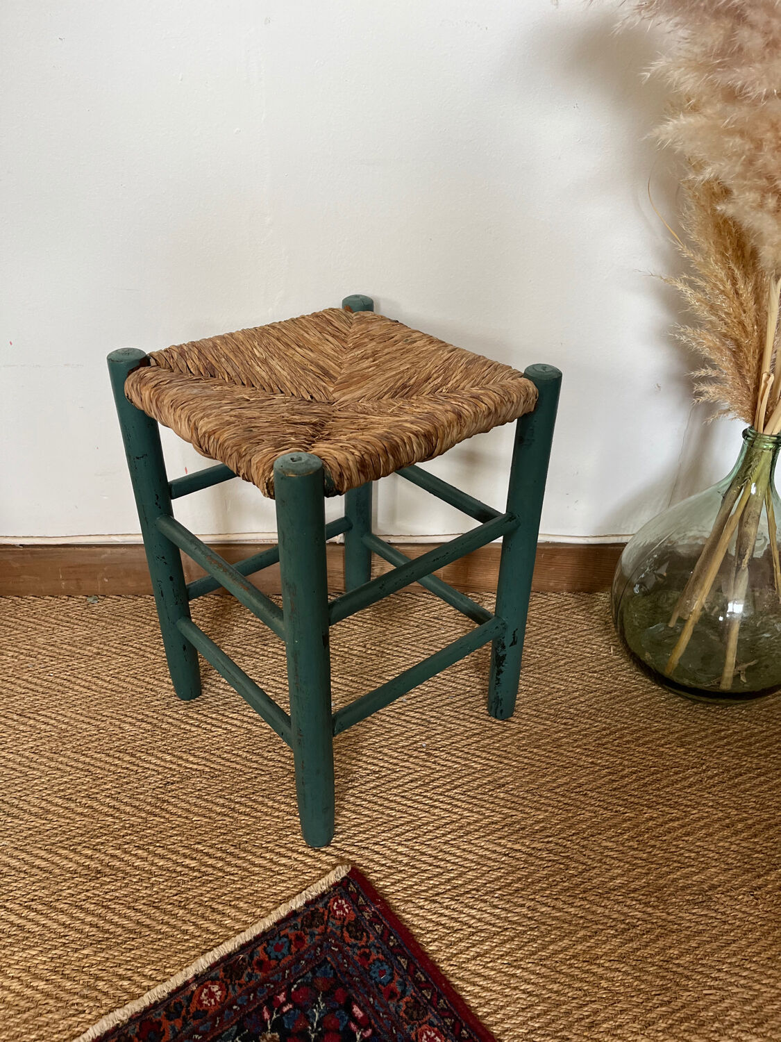 Vintage stool in green patinated wood and straw