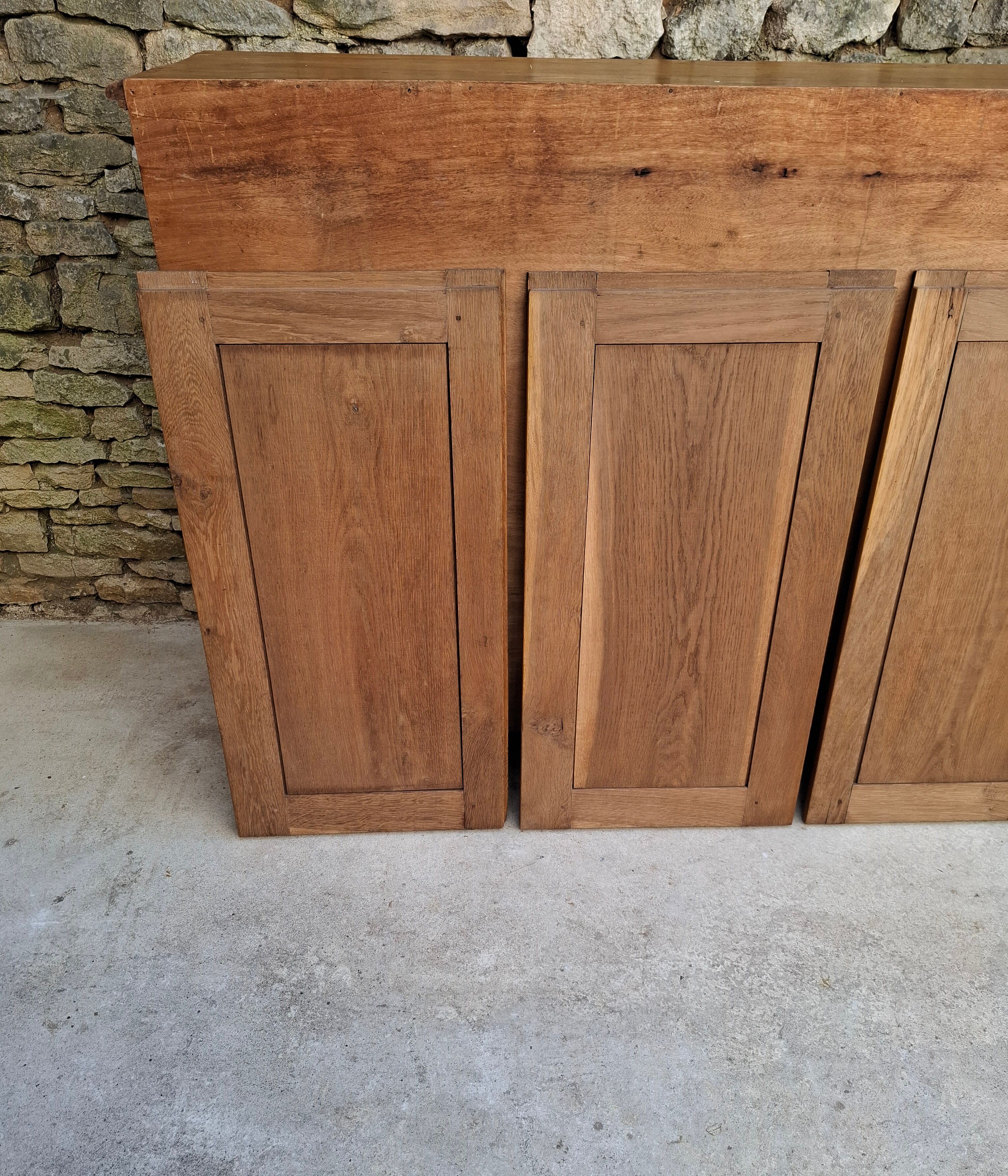 Oak workshop furniture with sliding doors.