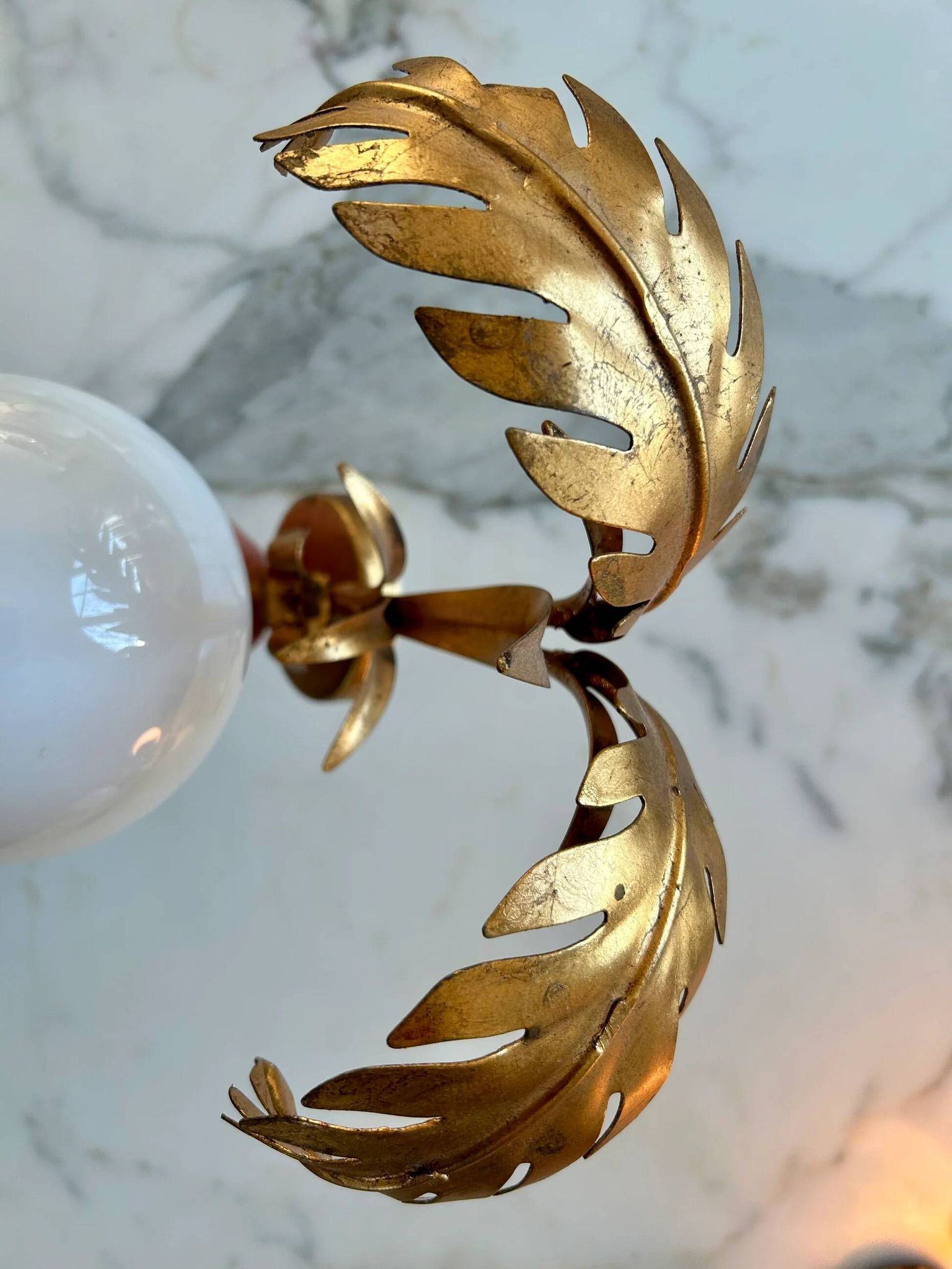 Pair of palm leaf wall lights in Hollywood Regency style with opaque globes by Hans Kögl, Germany, 1970s.