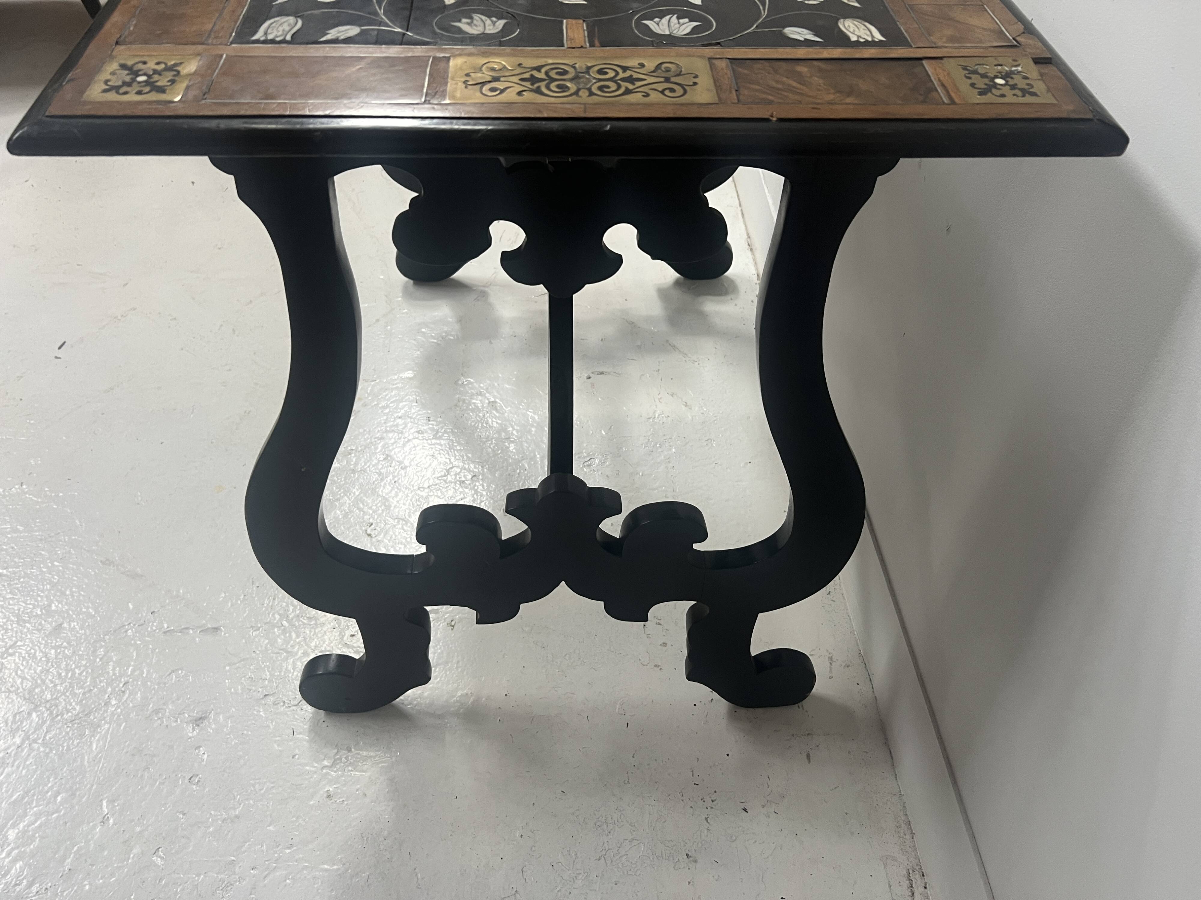 Blackened wood display table with marquetry top, Spain, 19th century.