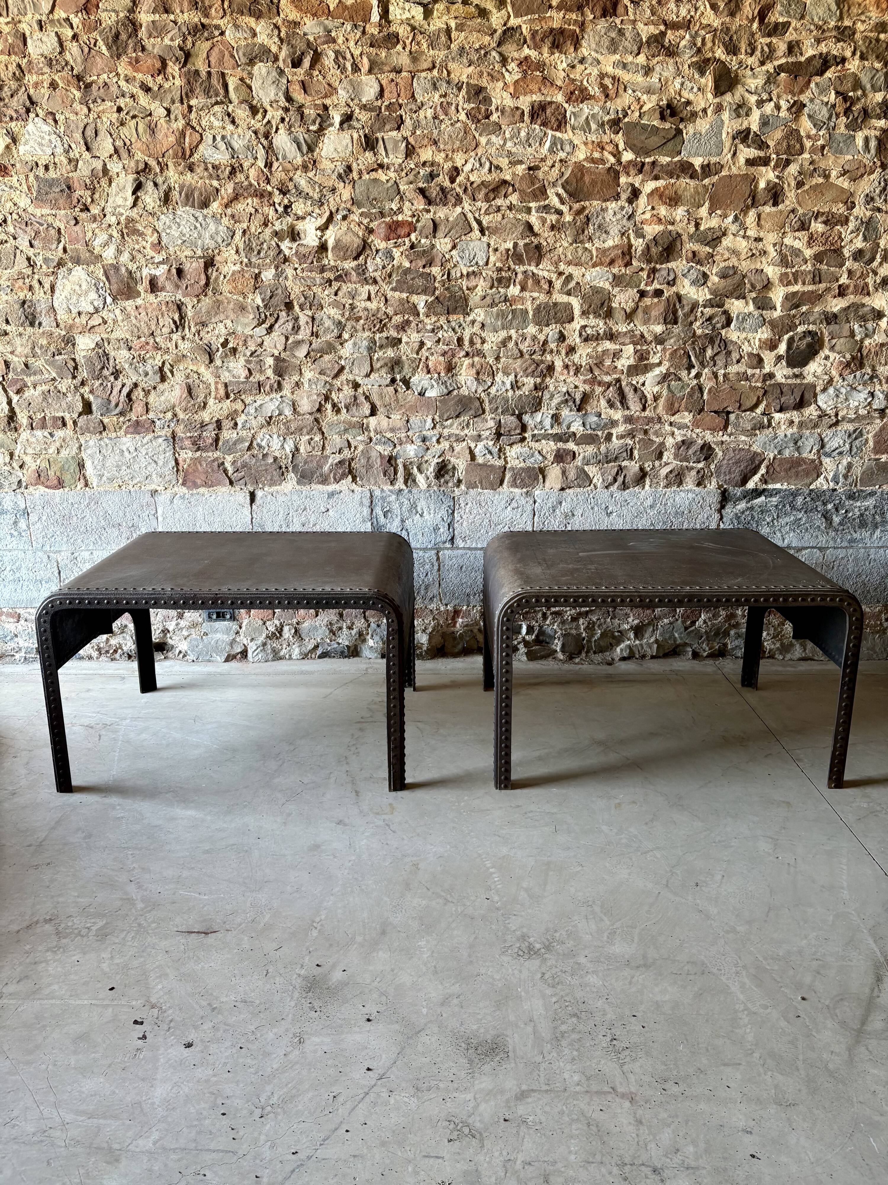 Pair of large riveted metal industrial tables